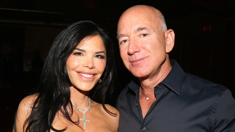 Jeff Bezos and Lauren Sanchez wear necklaces and pose in 2024