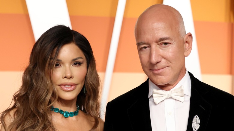 Lauren Sanchez and Jeff Bezos on the red carpet for the Vanity Fair Oscars party 2025, barely smiling