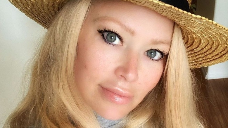 Jenna Jameson poses in a straw hat