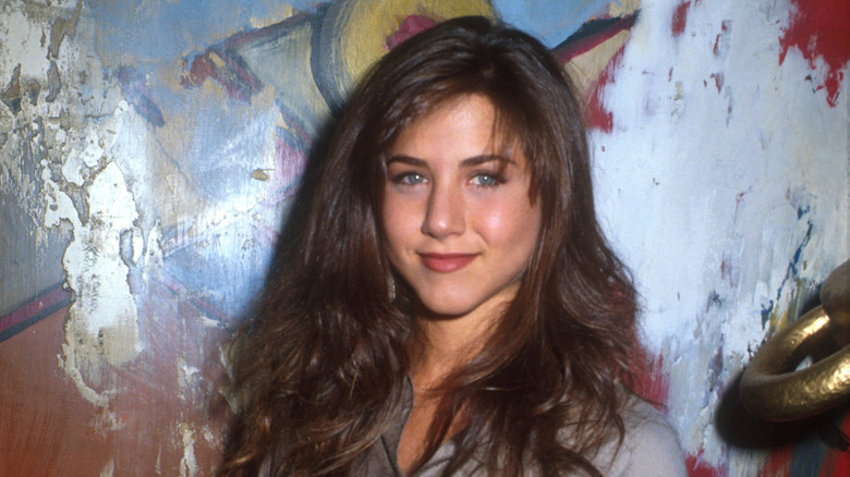 A young Jennifer Aniston poses for a photo. 