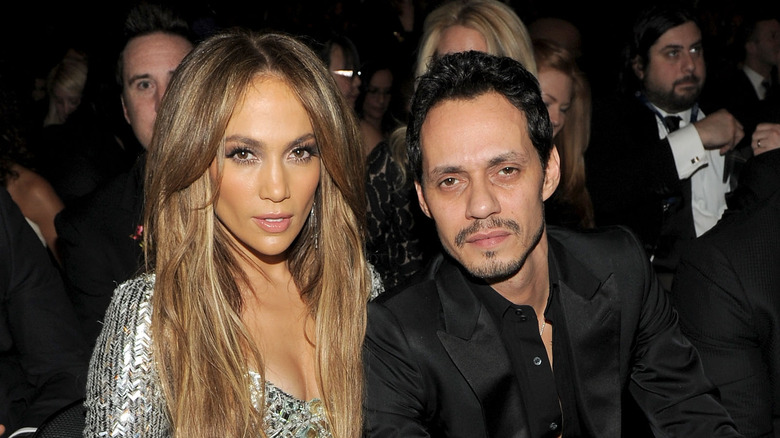 Jennifer Lopez and Marc Anthony sit together at event