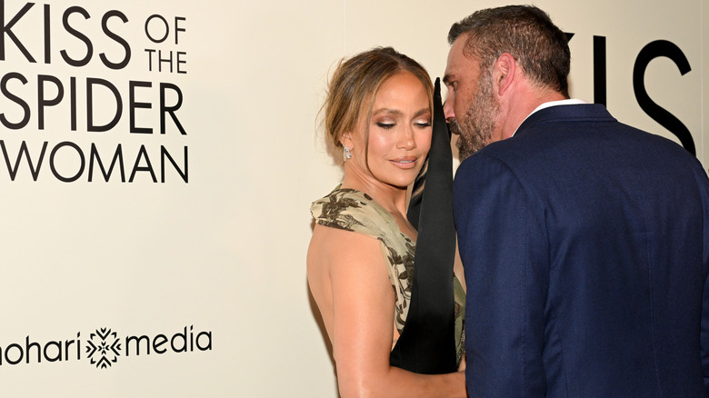 Ben Affleck whispering in Jennifer Lopez's ear