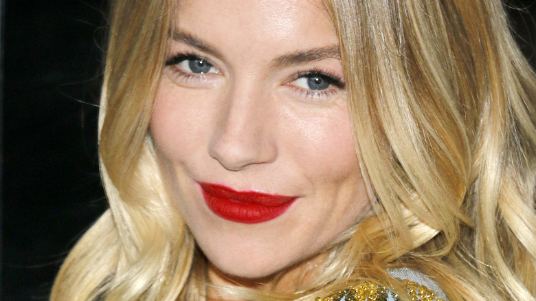 Sienna Miller smirking