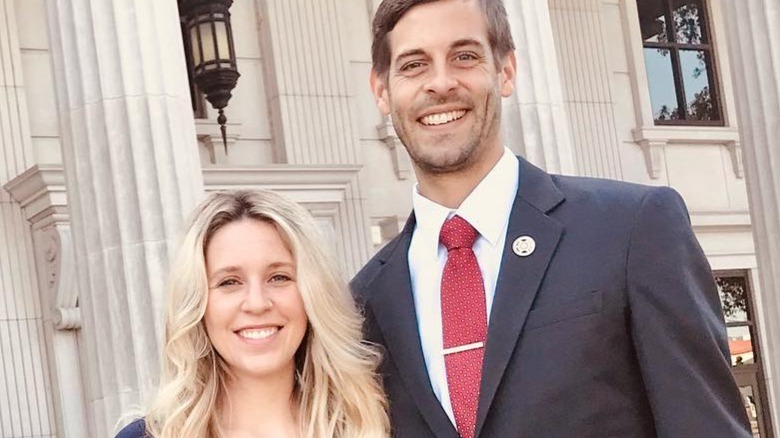 Derick Dillard and pregnant Jill Duggar Dillard in front of courthouse