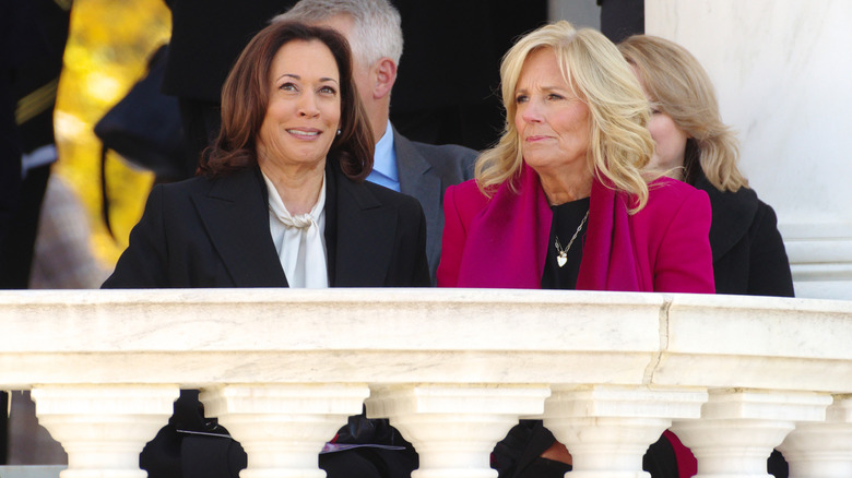 Kamala Harris sitting with Jill Biden at a Veterans Day ceremony at Arlington National Cemetery
