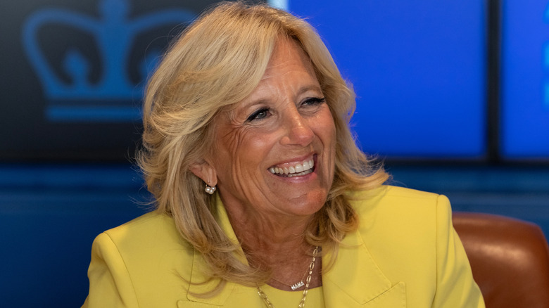 Jill Biden smiling in a yellow outfit
