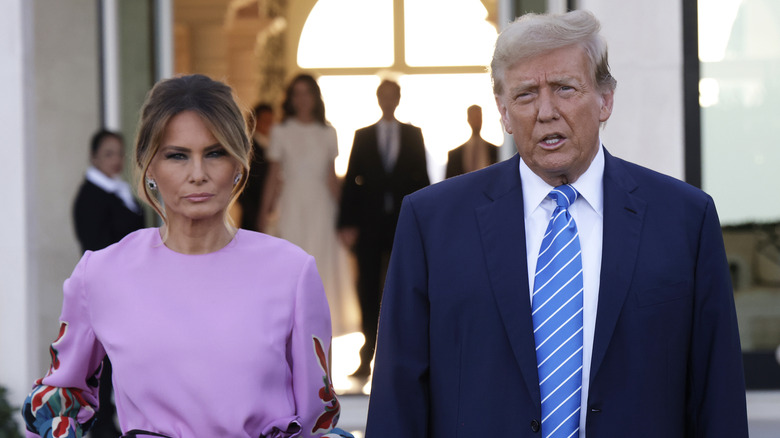 Melania Trump frowning as Donald Trump speaks