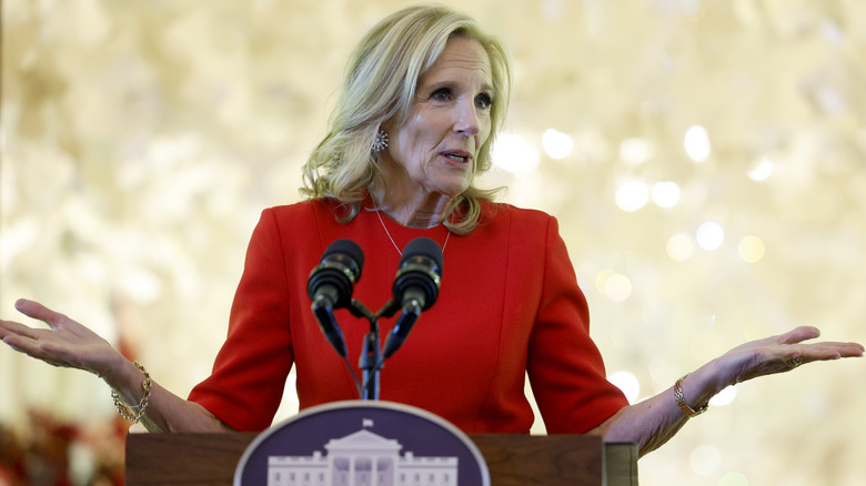 Jill Biden speaking at The White House in a red outfit.