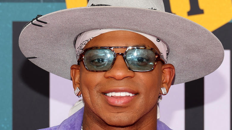 Jimmie Allen wearing hat and shades
