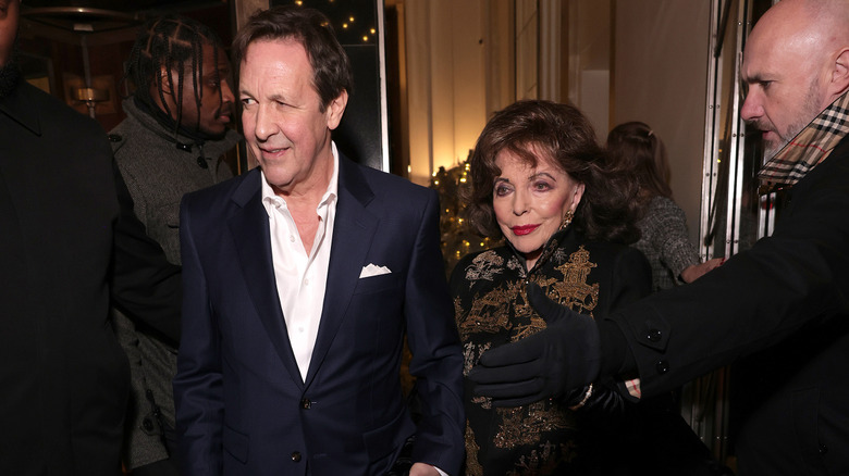 Joan Collins and Percy Gibson at the Claridge's and Burberry Christmas tree unveiling in 2025.