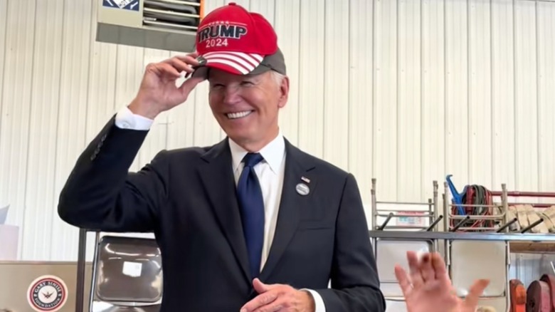 Joe Biden wearing a Trump hat
