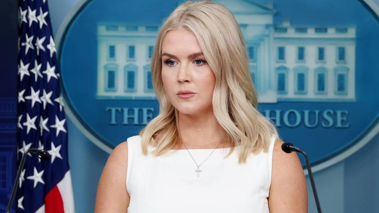 Karoline Leavitt looking stern in white dress