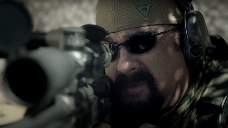 Steven Seagal holding weapon in Sniper: Special Ops