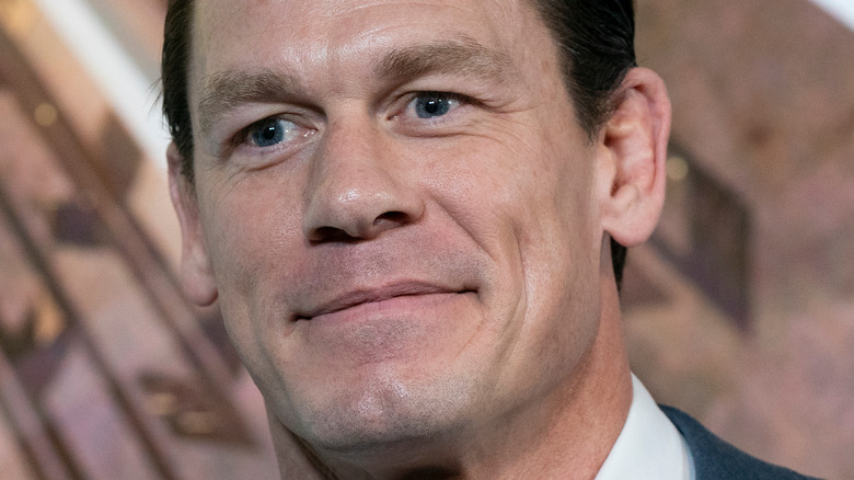 John Cena smiles wearing suit