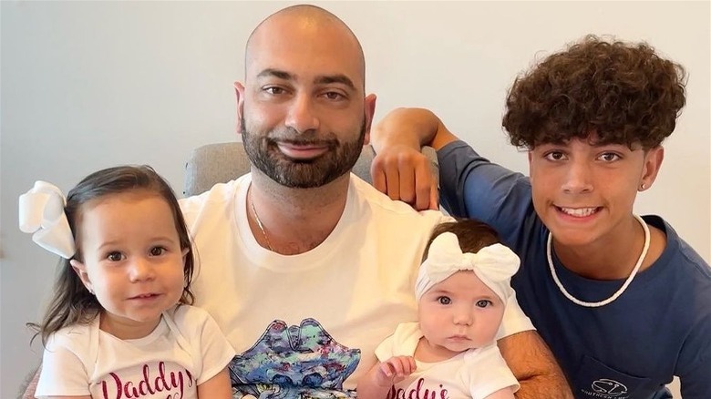John Fuda posing with his children