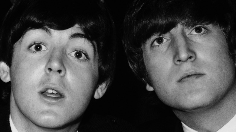 Paul McCartney and John Lennon in a black and white photo from the 1960s