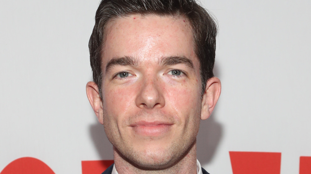 John Mulaney posing