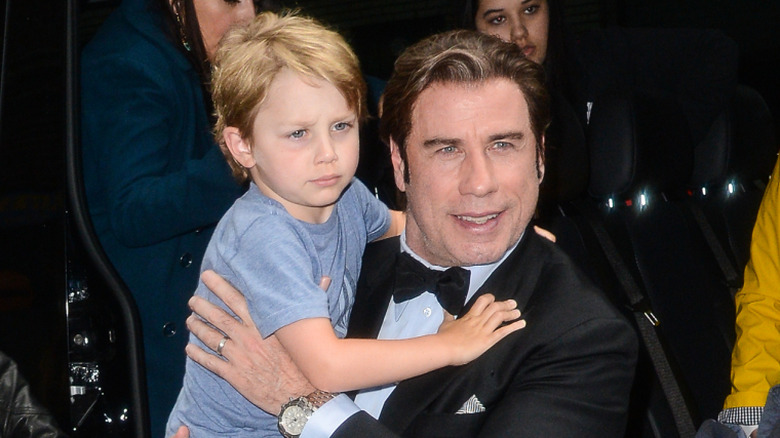 John Travolta carrying his son Benjamin Travolta as a toddler.