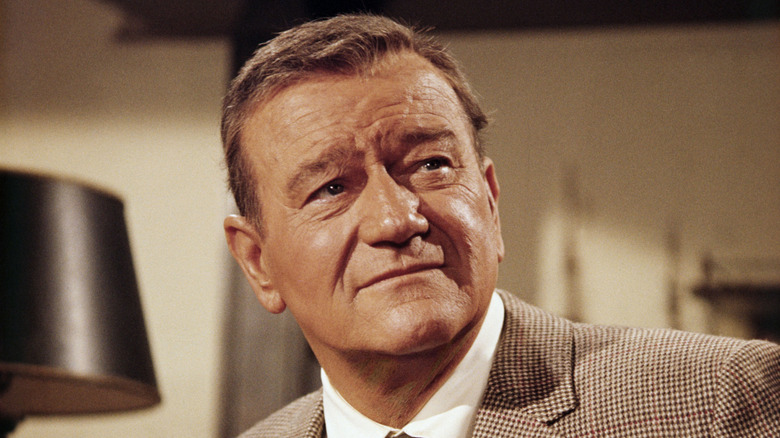 John Wayne smiling for posed photo