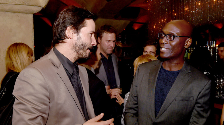 Keanu Reeves and Lance Reddick talking in 2014.