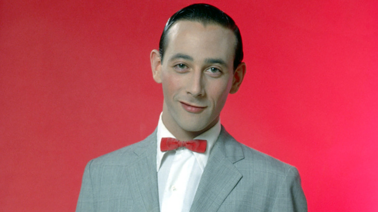 Pee-Wee Herman smiling in suit and bowtie