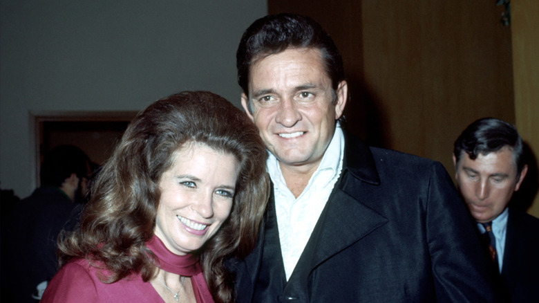 Johnny and June Carter Cash smiling for a photographer in 1969.