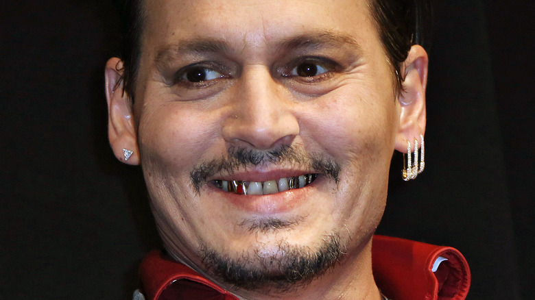 Johnny Depp smiling gold teeth diamond safety pin earrings