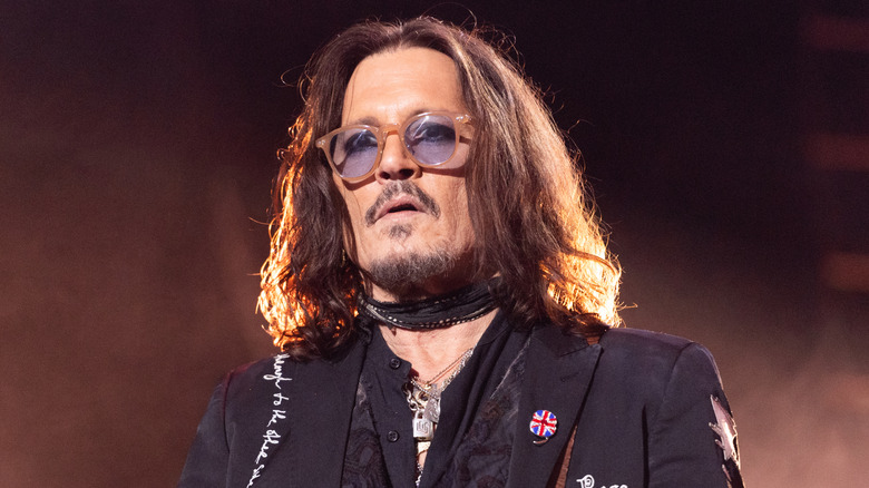 Johnny Depp wearing sunglasses with blue lenses.
