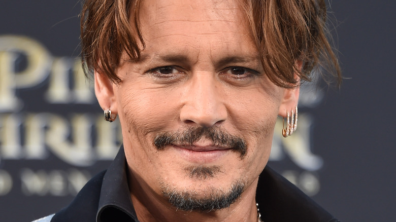 Johhny Depp smiling goatee safety pin earrings