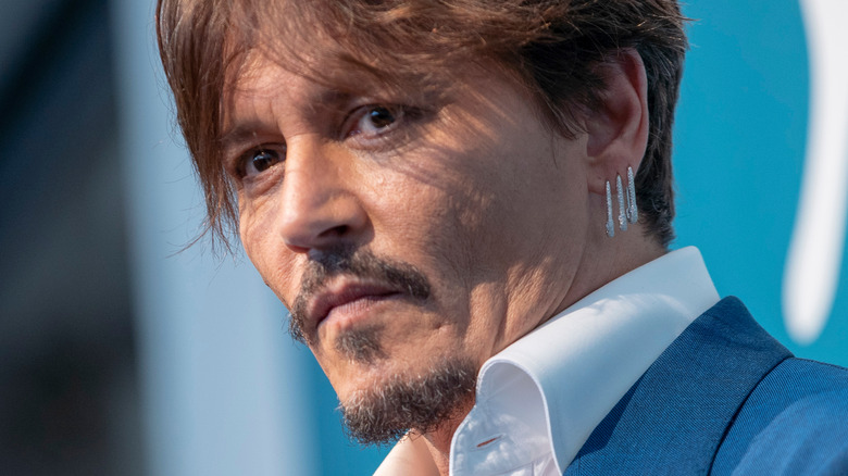 Johnny Depp wearing three earrings