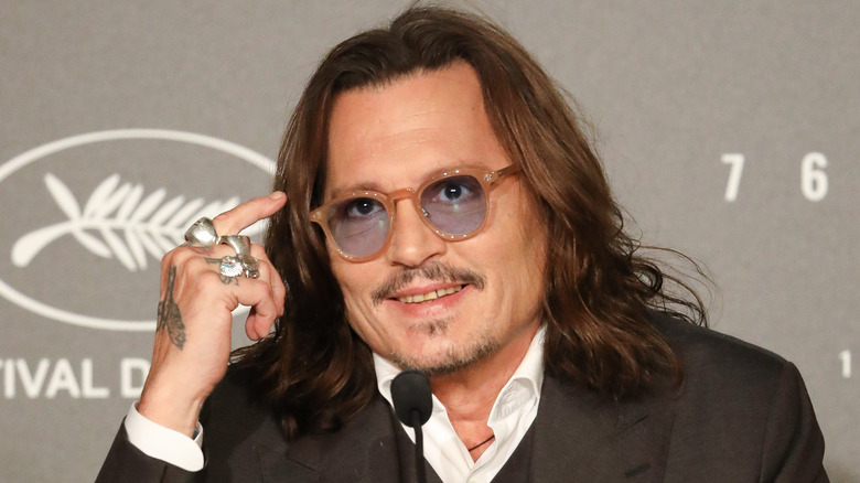 Johnny Depp smiling and speaking into a microphone