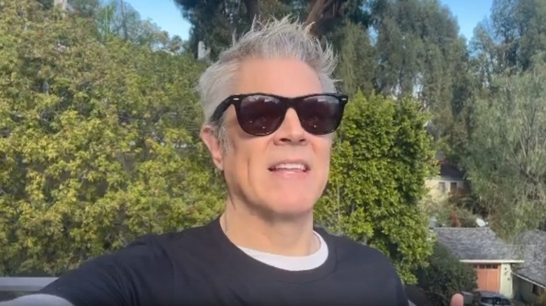 Johnny Knoxville outdoors wearing sunglasses.