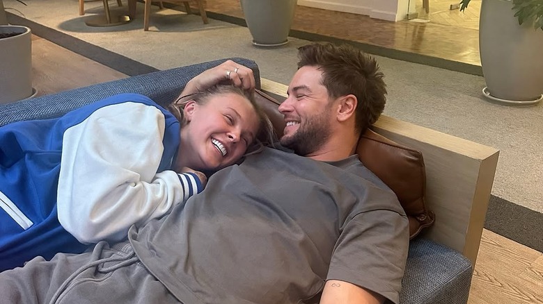 JoJo Siwa and Chris Hughes lie next to each other