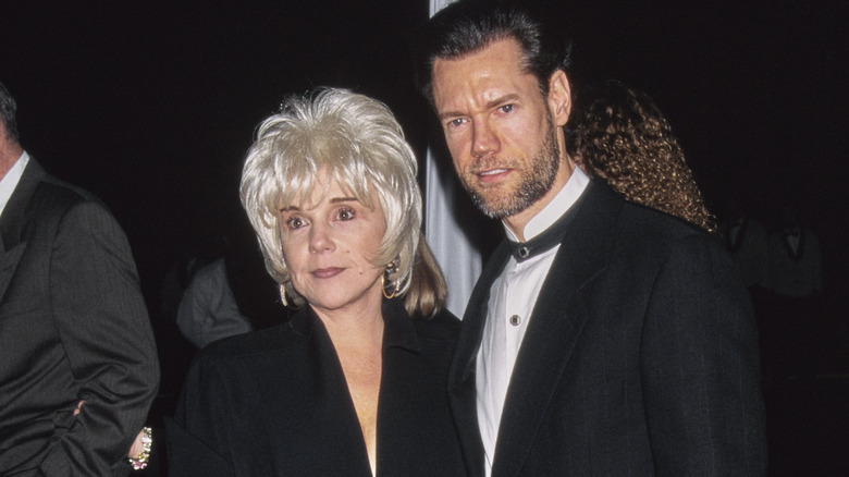 Randy Travis and his wife Elizabeth posing for a photo