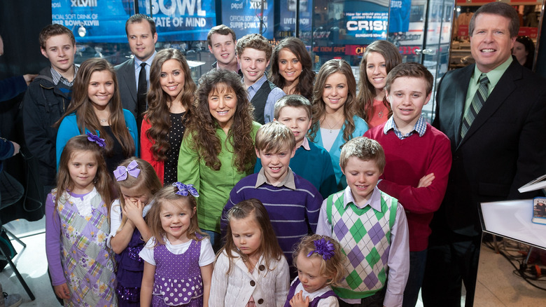 The Duggar family posing in TV studio