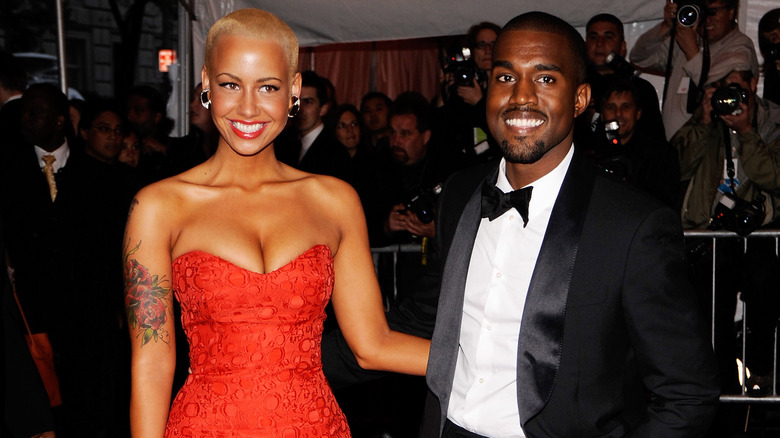 Amber Rose and Kanye West posing