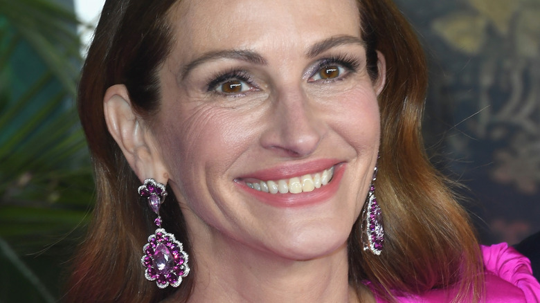 Julia Roberts wearing pink floral earrings smiling