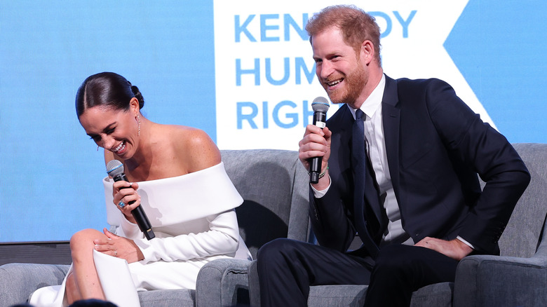 Meghan Markle and Prince Harry laughing onstage