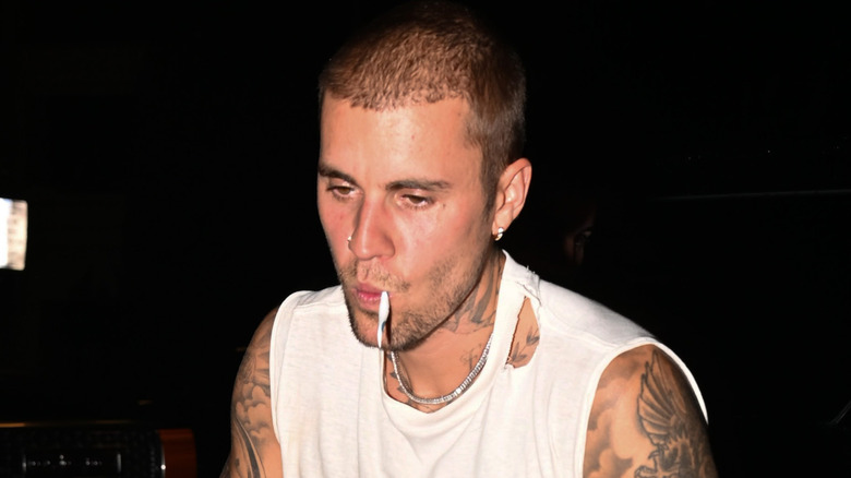 Justin Bieber in a ripped white tank, snapped by cameras on a night out