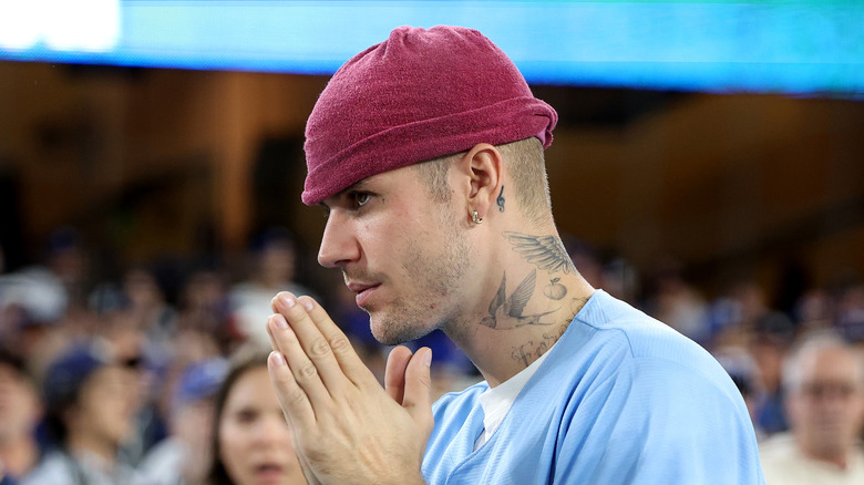 Justin Bieber making prayer hands at 2025 World Series