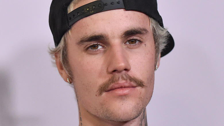 Justin Bieber baseball cap and mustache
