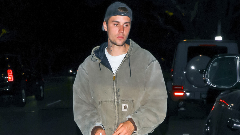 Justin Bieber walking in a parking lot