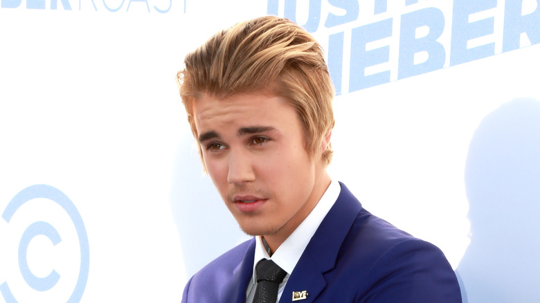 Justin Bieber posing in blue suit