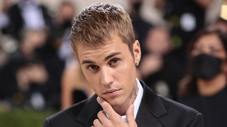 Jeremy Bieber touching his face