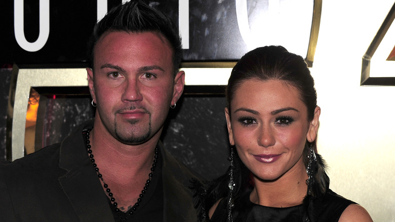 Jenni Farley and Roger Mathews posing together 