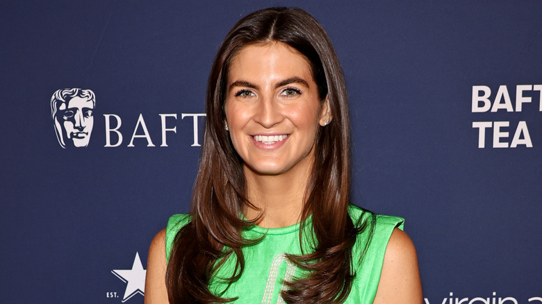 Kaitlan Collins posing in green dress at event.