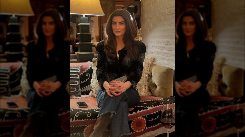 Kaitlan Collins posing while seated at Uncommon Threads
