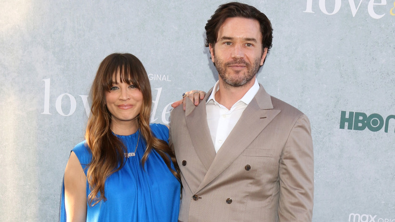 Kaley Cuoco in a blue silk sleeveless dress and a pendant with her daughter's name with Tom Pelphrey wearing a tan suit jacket and white button down shirt