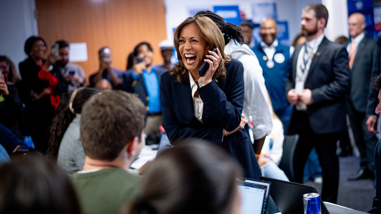 Kamala Harris using a phone at a gathering