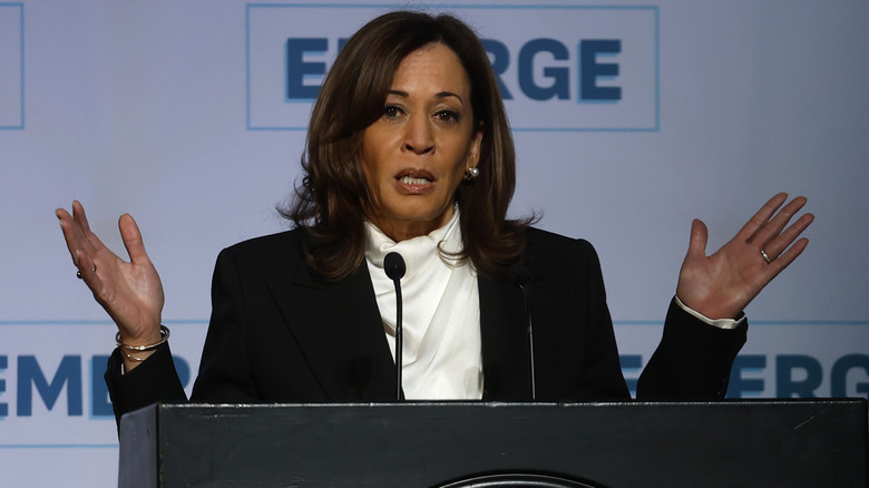 Kamala Harris holding both hands up while delivering a keynote address during the Emerge 20th Anniversary Gala at the Palace Hotel